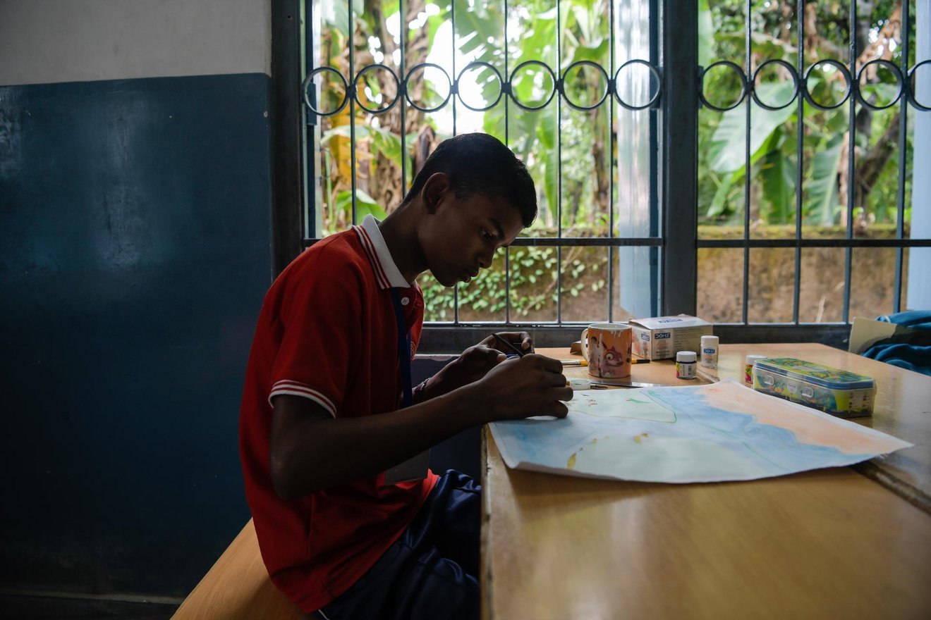 Priyansus Kharia (14) practices his drawing during an art class at St. Vincent's High School.