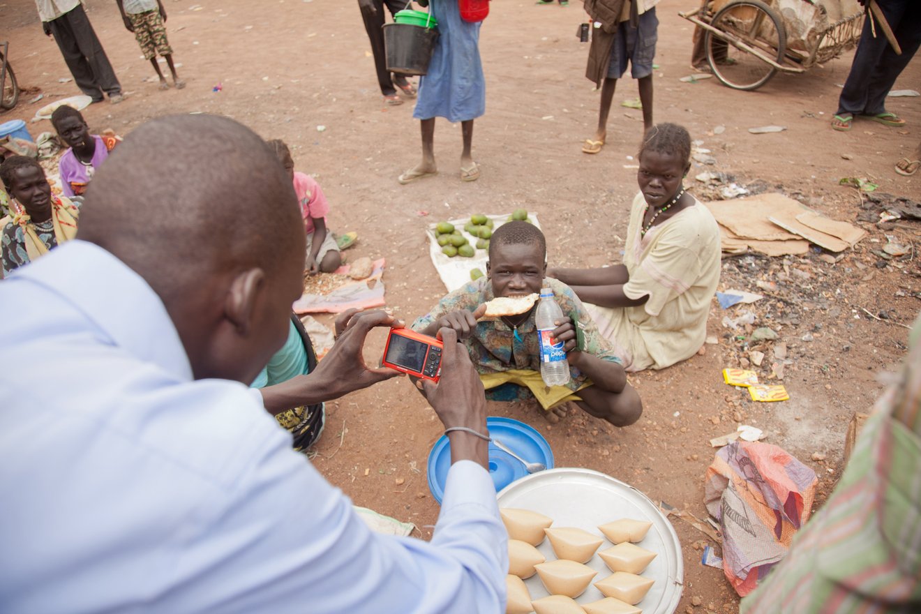 Kuajok, Warrap State, South Sudan. Saferworld Participatory Photography Project participant collecting images.