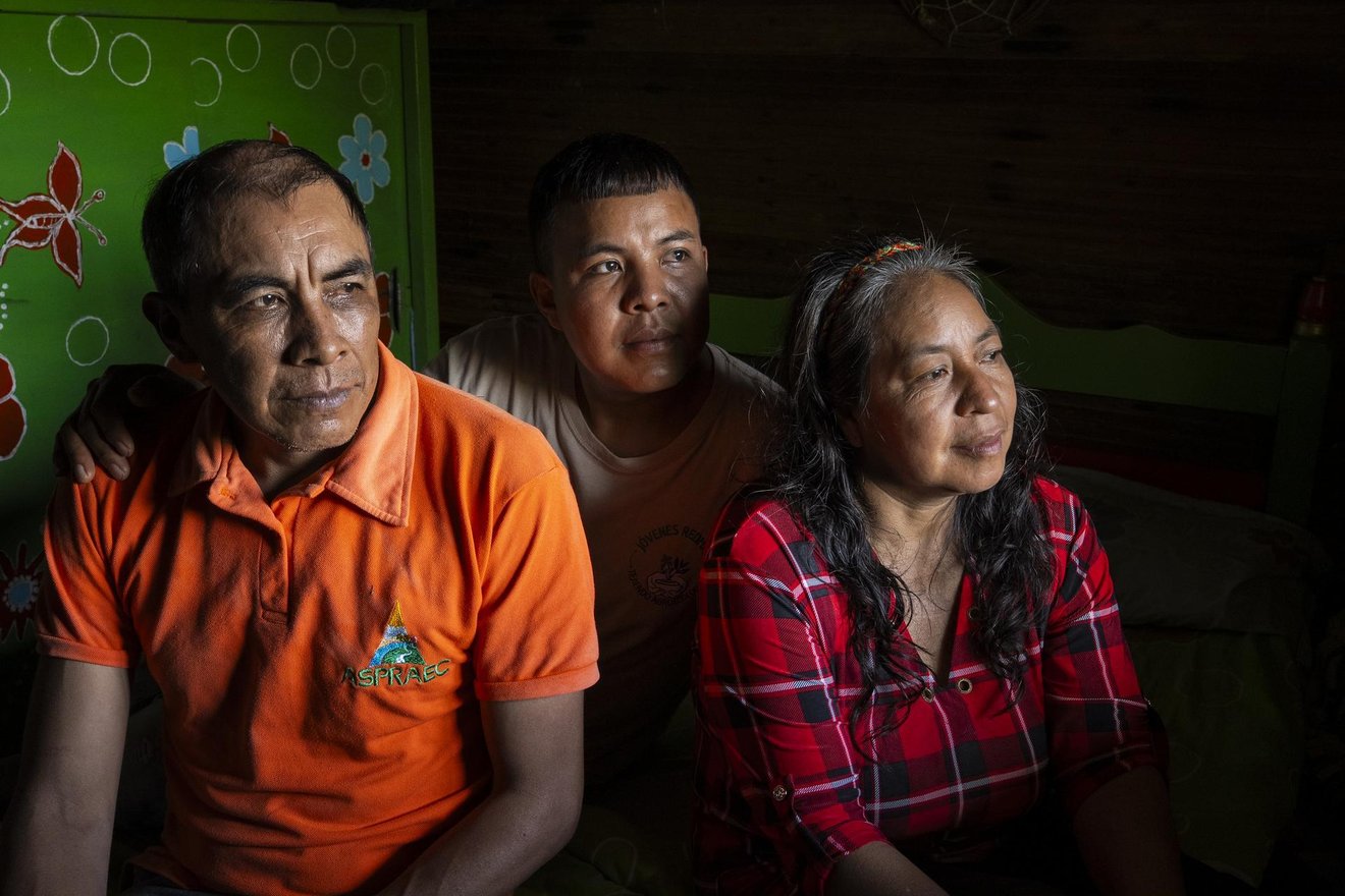 Cristian Quinayas (center), member Network of Agroecological Farmers' Markets in Valle del Cauca, poses for a portrait with his parents Marleny and Marino inside their house in Guacarí, Valle del Cauca department, Colombia, on May 7, 2026.