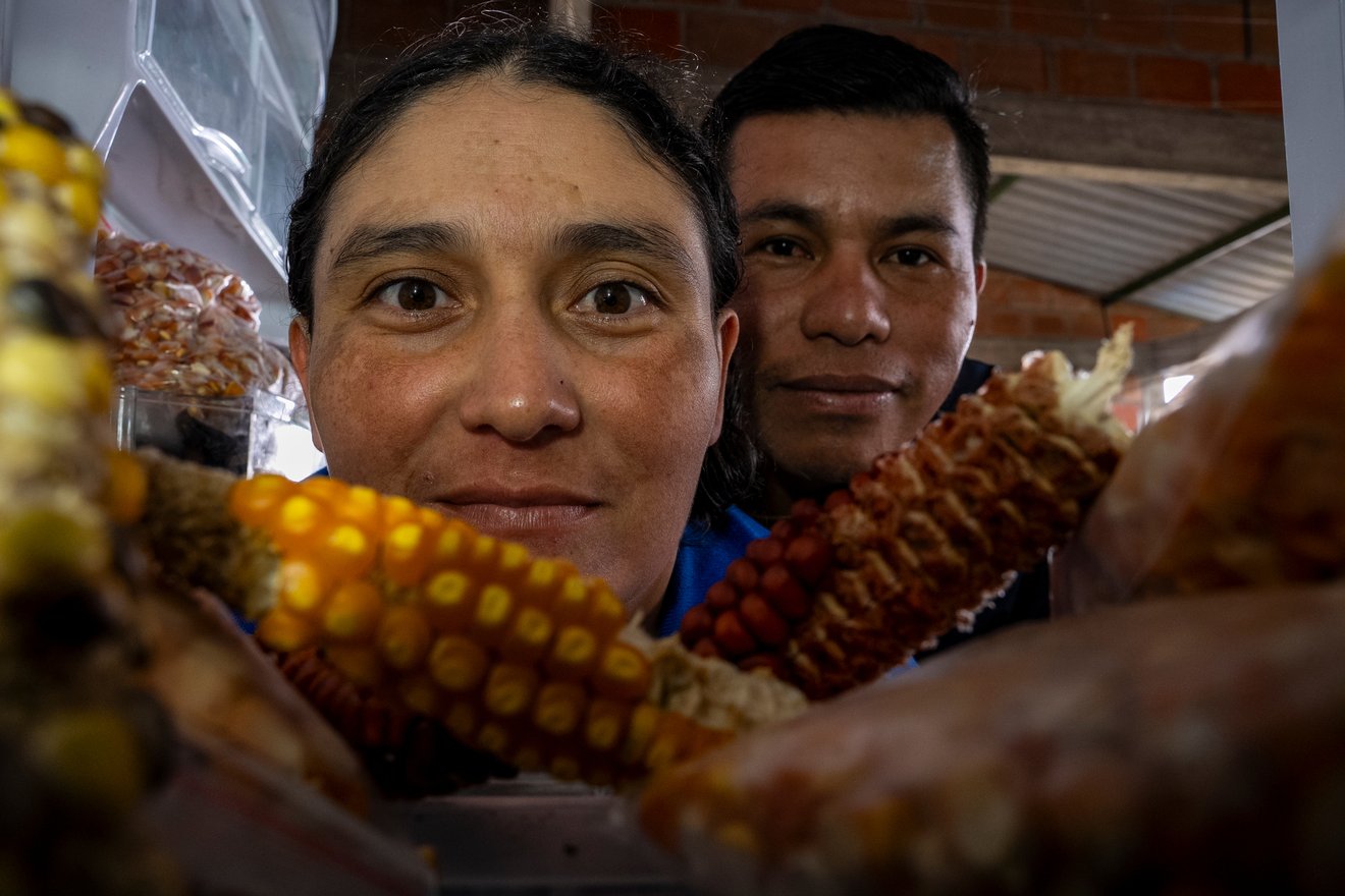 Members of the Network of Native Seed Protectors from Cauca Victoria Eugenia Chepes and his husband, Fabián Trochez, look inside the frigde where they store native seeds at the House of Native Seeds in Caldono, Cauca department, Colombia, on May 11, 2026.